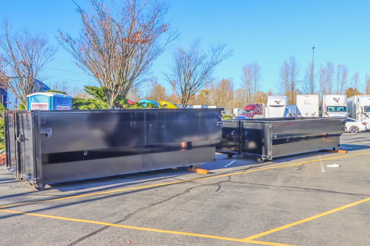 Professional dumpster rental service with roll-off container on residential driveway in Bayshore Gardens